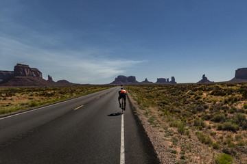 Road cyclist riding in the desert