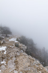standing in the fog at the top of a mountain
