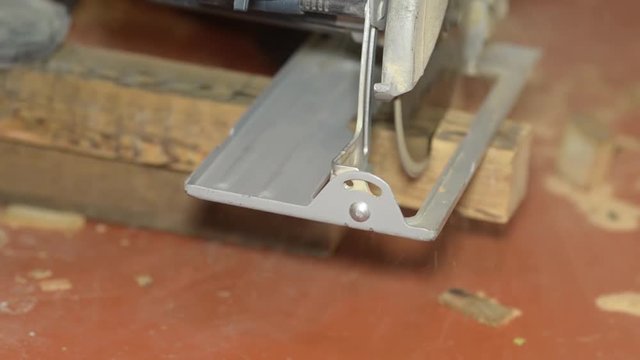 cutting wooden Board with electric saw close-up, home repair