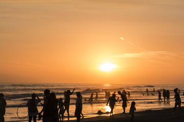 sunset at a beach with lots of people