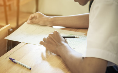 Obraz premium students writing on a paper for exams and admissions in high school, Thailand