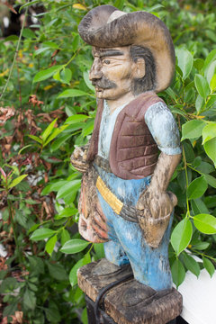 Cowboy carved from wood and beautifully painted.