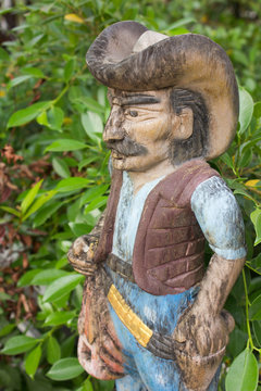 Cowboy carved from wood and beautifully painted.