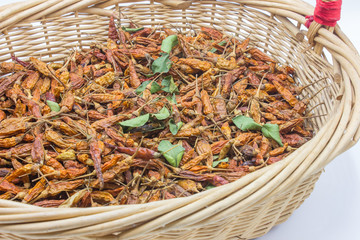 Dried red pepper in basket.