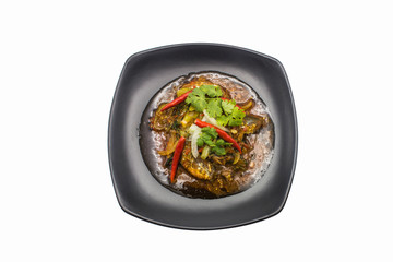 Fast food canned fish chillie in black dish on isolated white background.