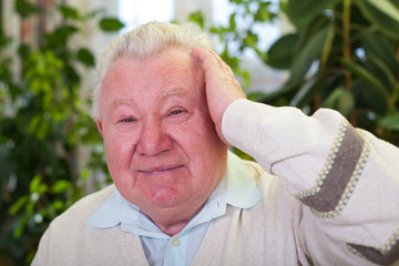Elderly man having a headache