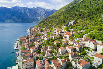 Beautiful city with red roofs in the mountains near the sea