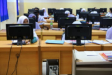 focus blur, the student with teacher learning business technology desktop computer in a classroom