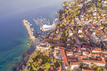 Fototapeta premium Top view of the resort town with red roofs and marina