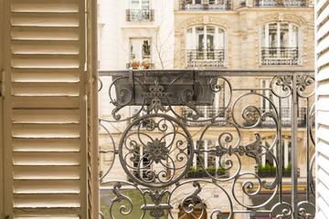 Balcony with decorative railing and shutter  in Paris, France