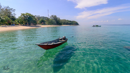 alone boat on clear sea water at Kapas Island, Terengganu, Malaysia