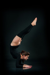 beautiful fitness woman doing stretching exercise on black background Hands Standing Upside Down