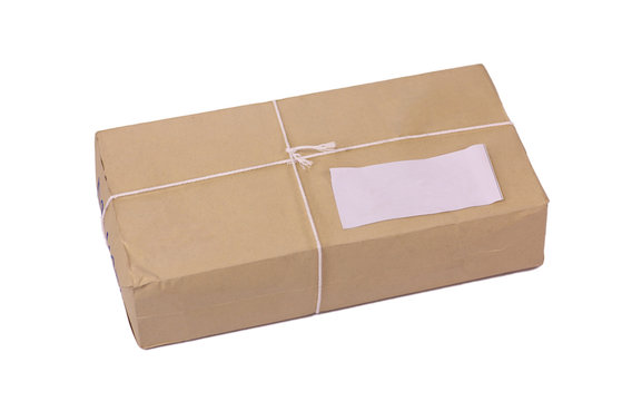 A parcel wrapped in brown paper and tied with rough twine and blank label