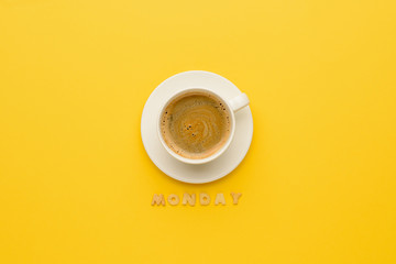 top view of cup of espresso coffee and monday lettering isolated on yellow