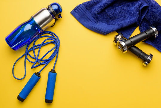 Top View Of Various Sports Equipment And Towel Isolated On Yellow