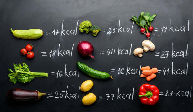 fresh vegetables and calories table isolated on black, healthy lifestyle concept