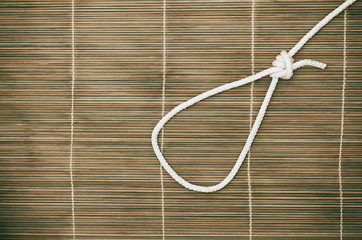 noose of rope on a wooden background