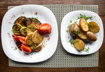 grilled vegetables with meat in a plate on a wooden table