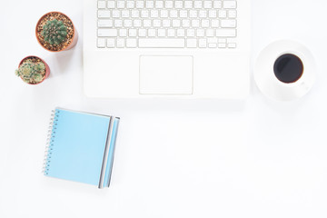 White computer laptop with coffee cup, notebook and cactus on white desk, Workspace concept