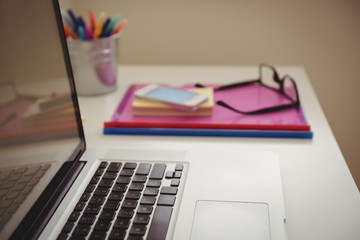 Close up of laptop by files