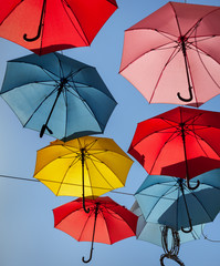 Multicolored umbrellas on street.