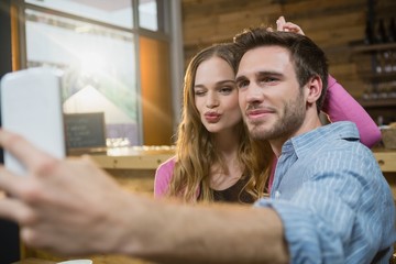 Young couple taking selfie on mobile phone