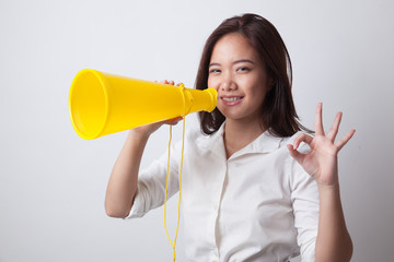Beautiful young Asian woman show OK  announce with megaphone.
