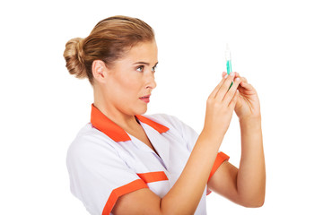 Female nurse or doctor with a syringe in hand