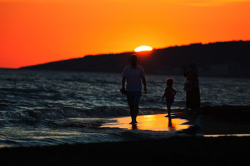 People at the beach silhouettes
