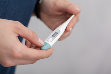 Sick women with a thermometer