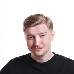 Fototapeta premium Mistrustful man with sly smile, makes fun of something