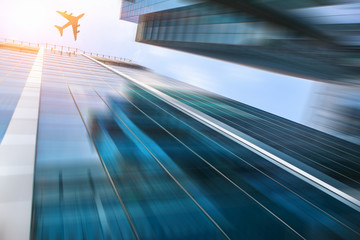 Bottom view of airliner over skyscrapers . Mixed media