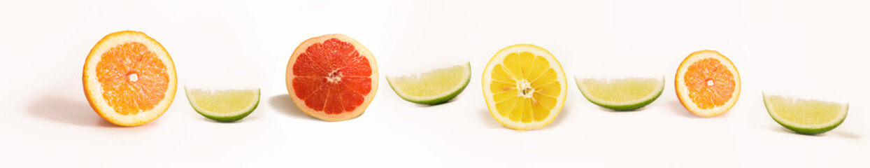 Fototapeta na wymiar Panoramic Bright and Fresh Lemon, Orange, Grapefruit, Lime for Skinali. Colorful Citrus Fruit Slices Background. White Backside.