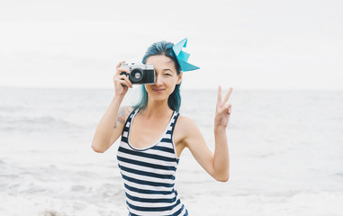 Sailor style beautiful girl with photo camera.