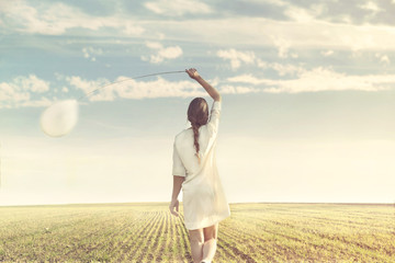 dreamy woman walking towards infinity with his white balloon in nature - obrazy, fototapety, plakaty