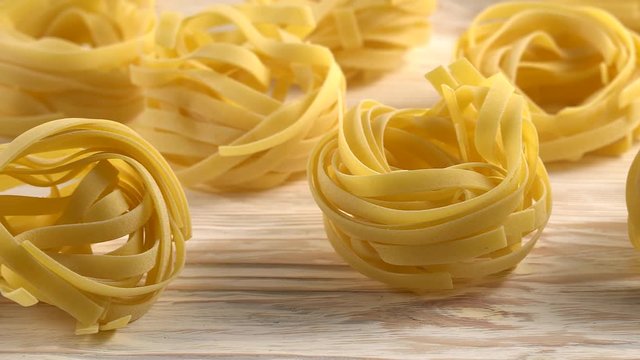 pasta, oil, tomatos and garlic on wooden background