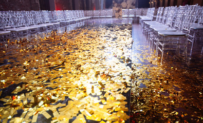 Golden confetti With Sparkling Glitter in fashion exhibition podium