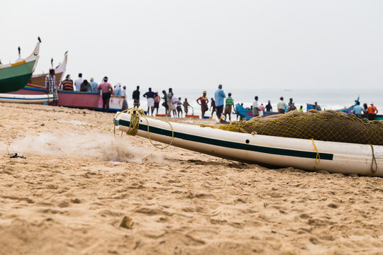 Fishing boat with net and fishermen on backside waiting a catch.