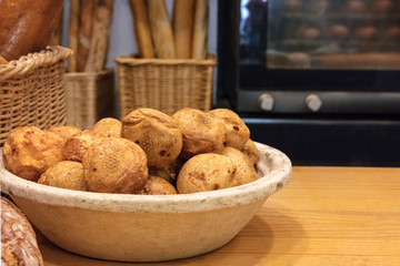Profiteroles in Spanish bakery with oven in blurred background