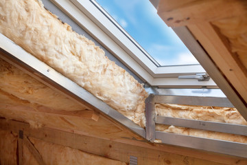 Plastic (mansard) or skylight window on attic with environmentally friendly and energy efficient...