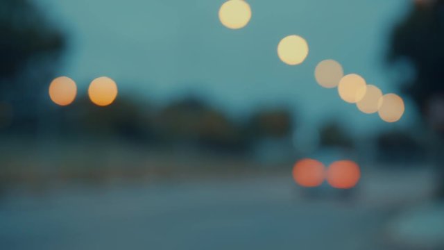 blurred female runner crossing city street at dusk