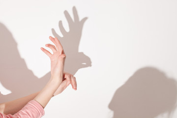 shadows from the hand on white wall