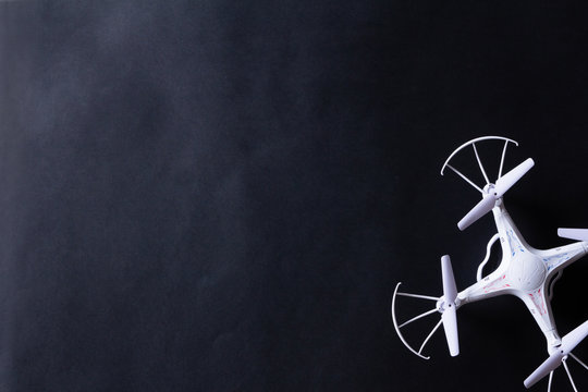 Photo of white quadrocopter on black background