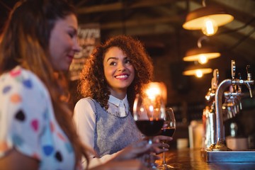 Young women interacting with each other at counter