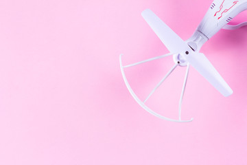 Photo of white quadrocopter on bright pink background