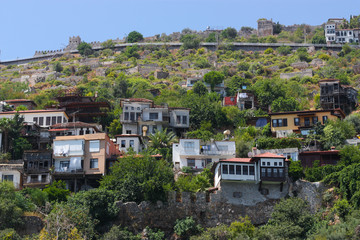 Fototapeta na wymiar View of the colored houses on the hill among the greenery.