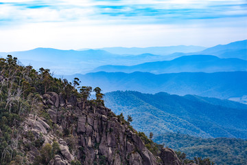 Fototapeta na wymiar Mount Buffalo National Park - Rocks and layers of blue hills. Victoria, Australia