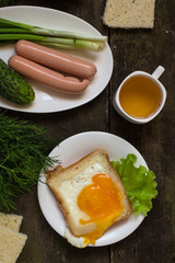 Sausages, scrambled eggs in bread, lettuce and greens - breakfast