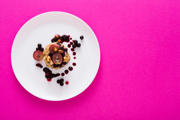 Healthy breakfast - oatmeal porridge on pink with copy space
