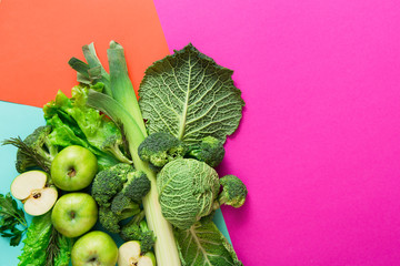 Flat lay of green vegetables on bright background